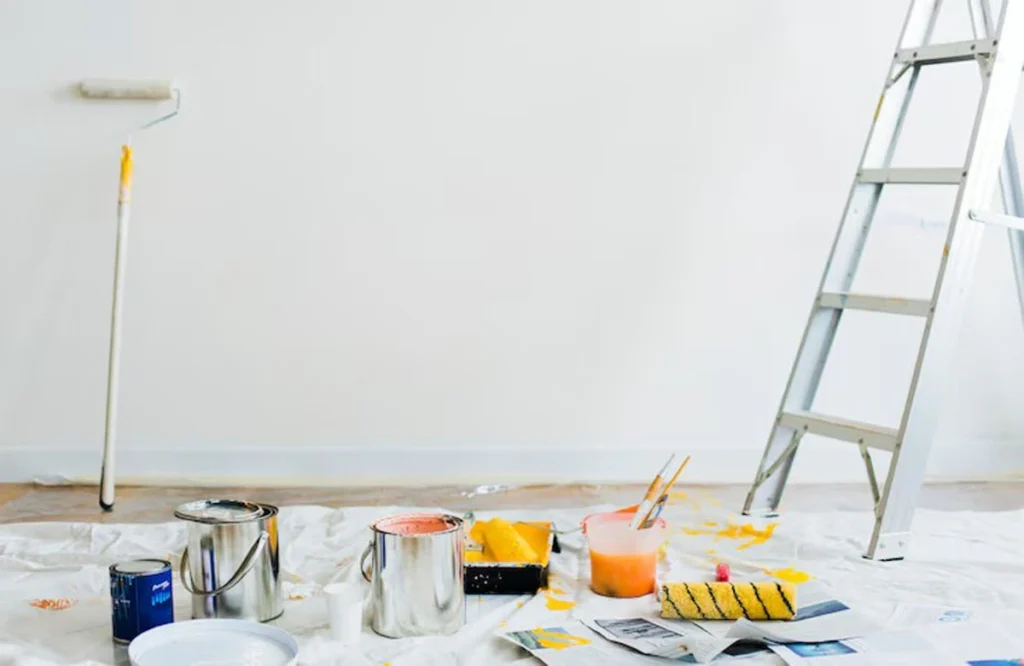 A display of premium paint brands with rollers, color samples, and ladders, showcasing the best paint brands for UAE homes and office interiors.