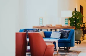 Discover the best interior colors for UAE apartments that blend modern design with comfort. This image showcases a cozy living room with blue and red furniture for an elegant look.